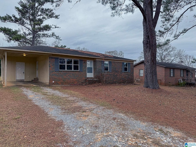 ranch-style home featuring a carport