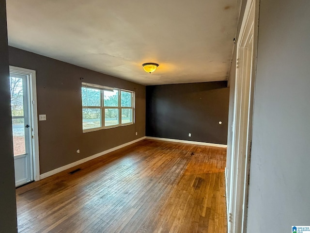 spare room with hardwood / wood-style floors