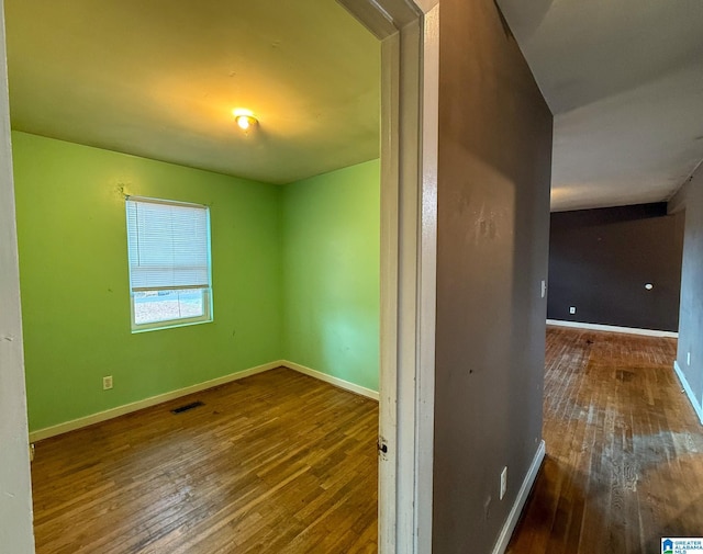 spare room featuring dark hardwood / wood-style floors