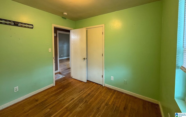 unfurnished bedroom with hardwood / wood-style floors