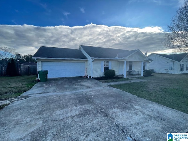 ranch-style home with a front lawn and a garage