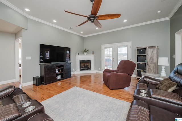 living room featuring ceiling fan, crown molding, and hardwood / wood-style flooring