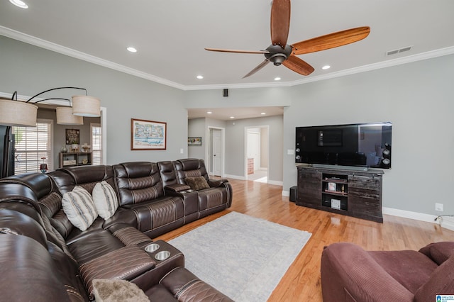 living room featuring ceiling fan, light wood-type flooring, and ornamental molding