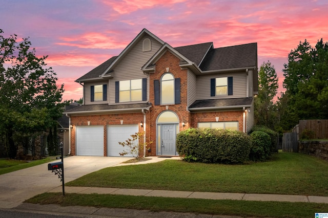 view of front facade featuring a garage and a lawn