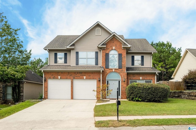 view of front of property with a garage and a front lawn