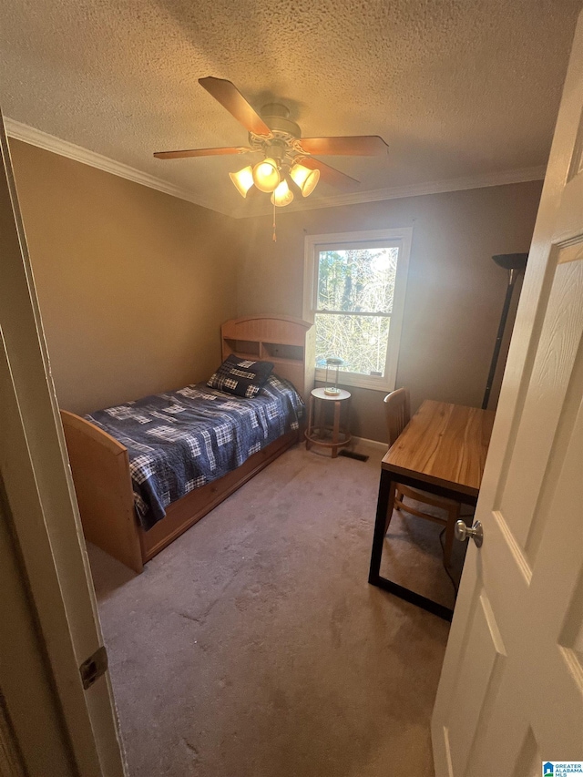 bedroom featuring carpet flooring, ceiling fan, ornamental molding, and a textured ceiling