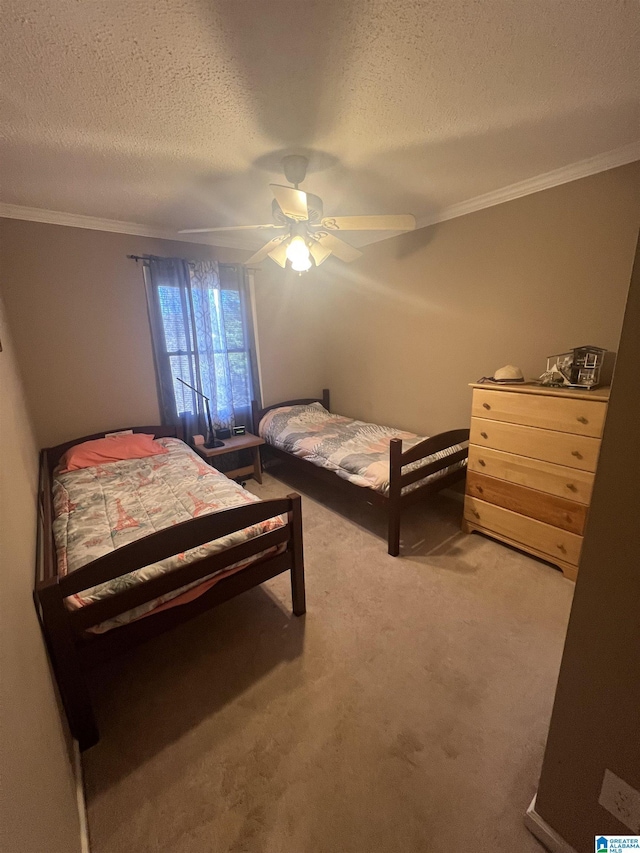 bedroom with ceiling fan, crown molding, carpet, and a textured ceiling