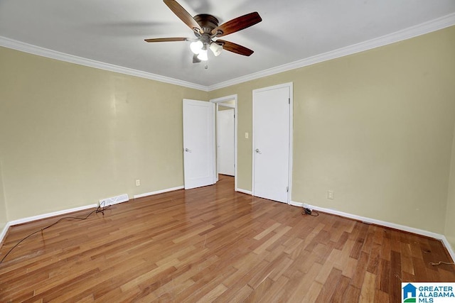 spare room with ceiling fan, ornamental molding, and light hardwood / wood-style flooring