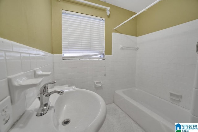 bathroom with tile patterned floors, sink, and tile walls