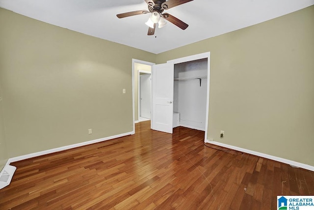 unfurnished bedroom with hardwood / wood-style floors, a closet, and ceiling fan