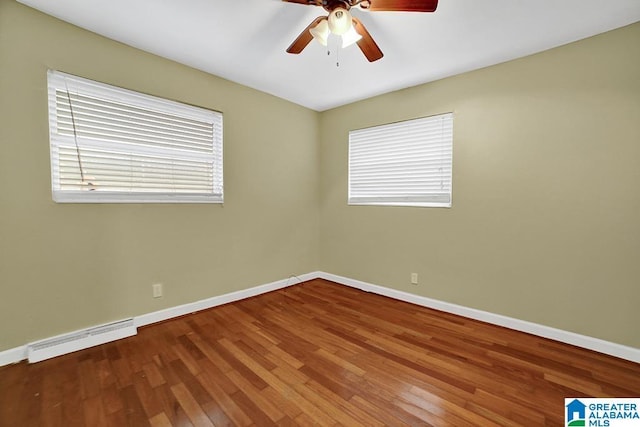 spare room with ceiling fan and wood-type flooring