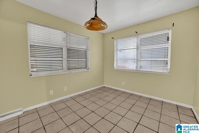 spare room featuring light tile patterned flooring