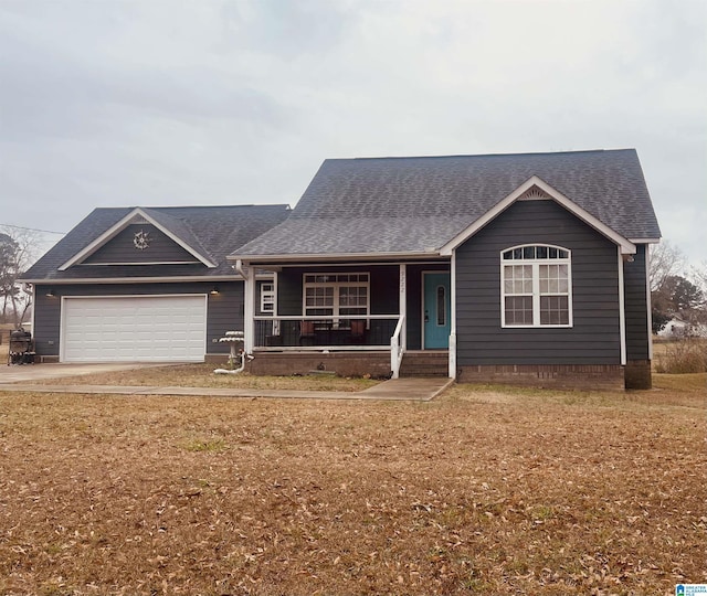 ranch-style house with covered porch, a garage, and a front yard