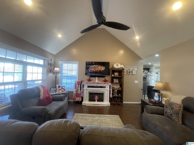 living room featuring dark hardwood / wood-style flooring, high vaulted ceiling, plenty of natural light, and ceiling fan