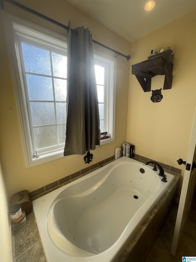 bathroom featuring tiled tub