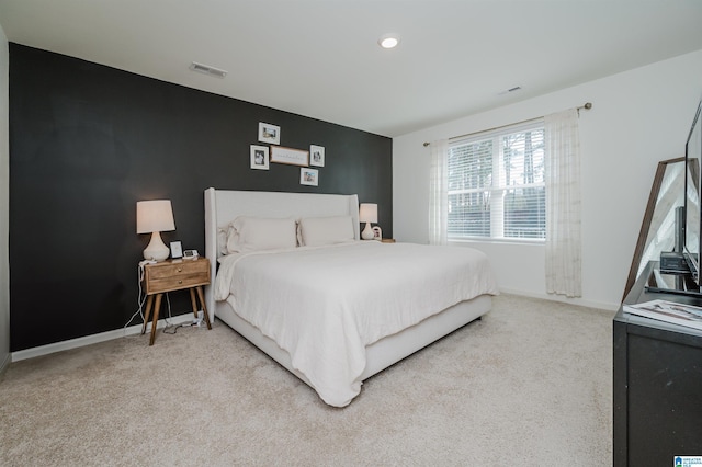 bedroom with light colored carpet