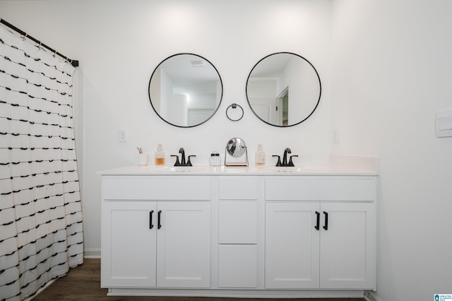 bathroom with a shower with curtain, vanity, and wood-type flooring