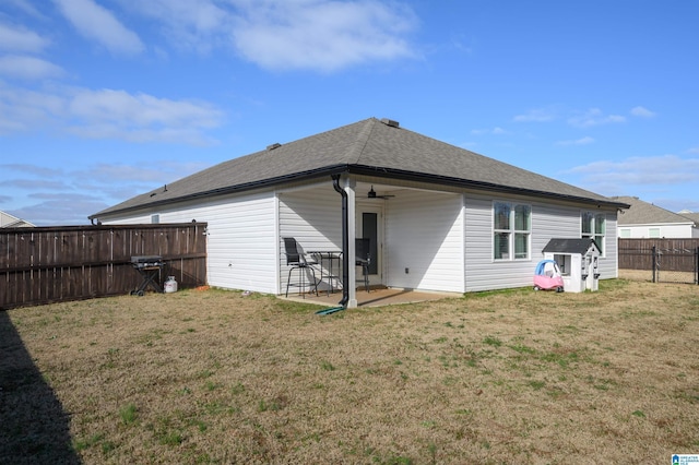 rear view of house featuring a yard and a patio