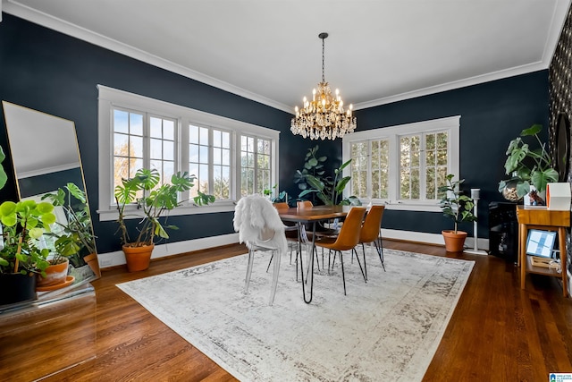 dining space featuring crown molding, dark hardwood / wood-style flooring, and a notable chandelier