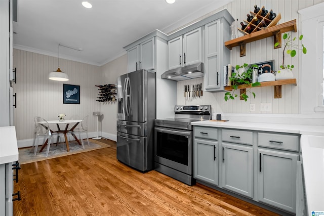 kitchen featuring appliances with stainless steel finishes, ornamental molding, gray cabinetry, hardwood / wood-style flooring, and hanging light fixtures