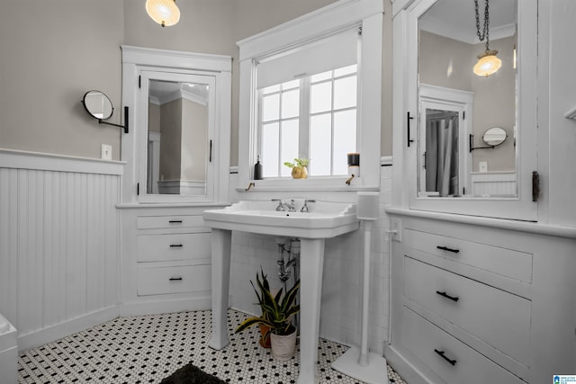 bathroom with tile patterned flooring and ornamental molding