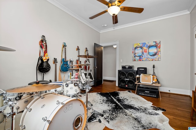 misc room with ceiling fan, ornamental molding, and dark wood-type flooring