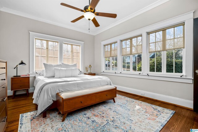 bedroom with dark hardwood / wood-style flooring, ceiling fan, and ornamental molding