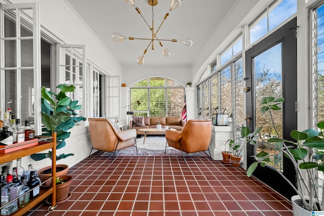 sunroom / solarium featuring a notable chandelier and plenty of natural light