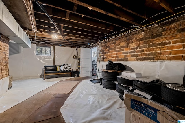 basement featuring brick wall