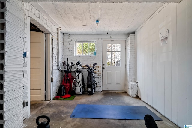 interior space featuring wood walls and concrete flooring