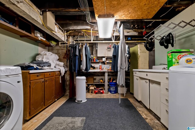 clothes washing area featuring cabinets and washer / clothes dryer