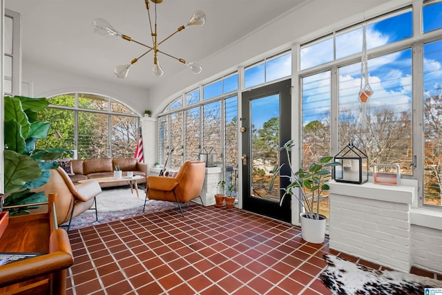 sunroom / solarium featuring an inviting chandelier