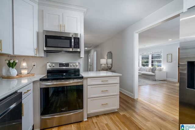 kitchen with white cabinetry, light wood-type flooring, and appliances with stainless steel finishes