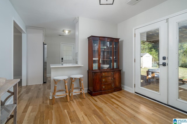 dining space featuring french doors and light hardwood / wood-style floors