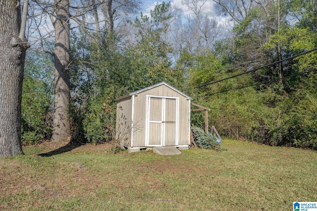 view of outbuilding with a yard