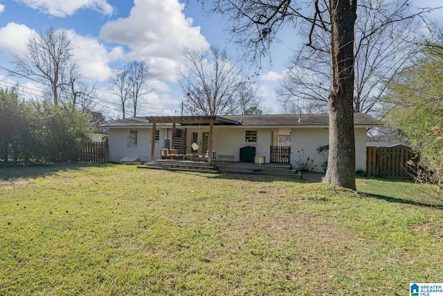 back of house featuring a lawn