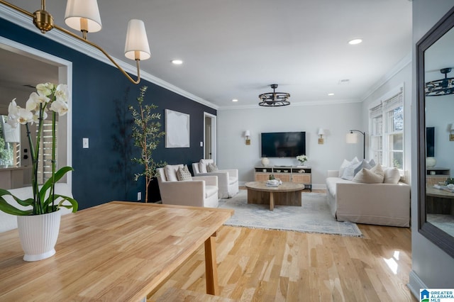 living room featuring hardwood / wood-style floors, crown molding, and a notable chandelier