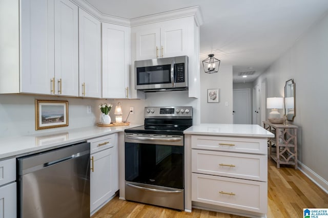 kitchen with light hardwood / wood-style floors, white cabinetry, and appliances with stainless steel finishes