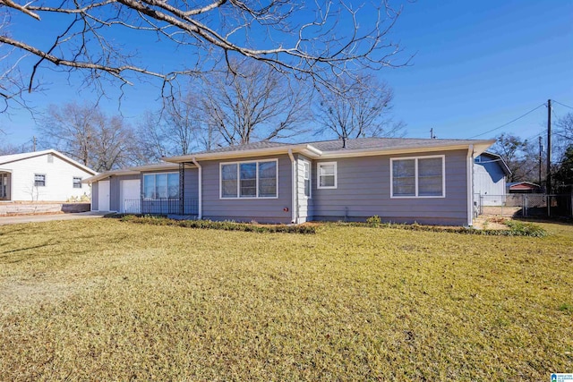 ranch-style house featuring a garage and a front lawn