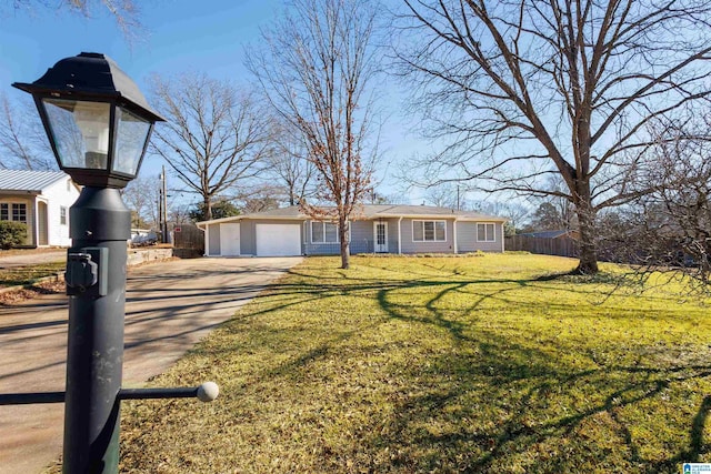 view of front of property with a garage and a front lawn