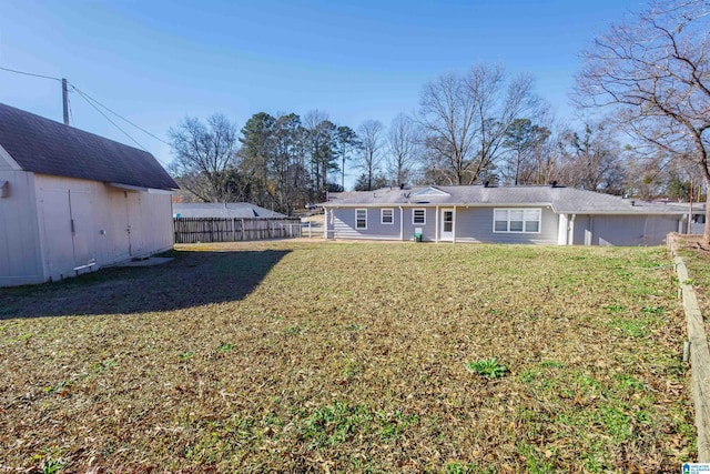 back of house featuring a yard