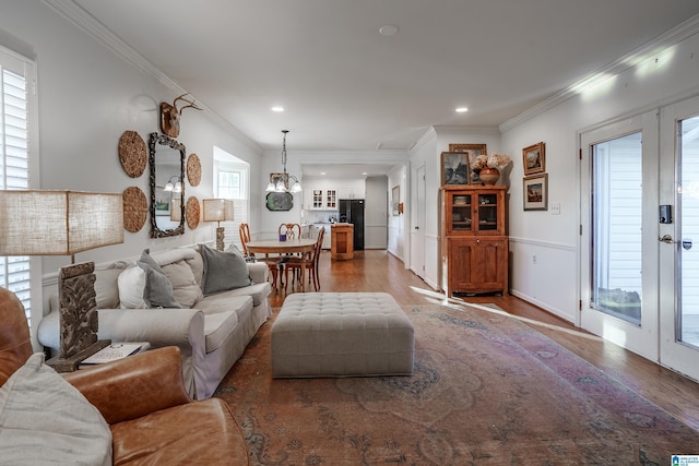 living room featuring a wealth of natural light and ornamental molding