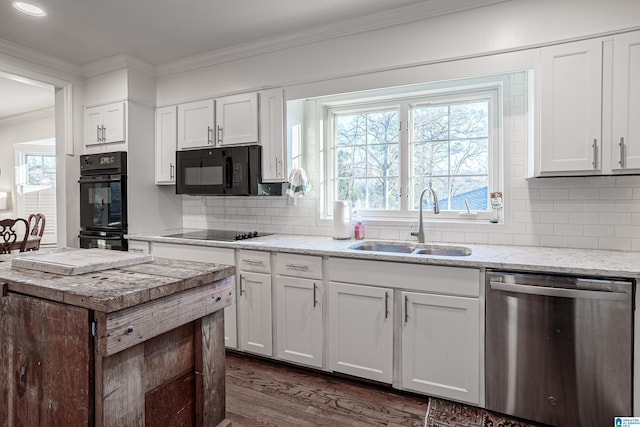 kitchen with sink, white cabinetry, and black appliances