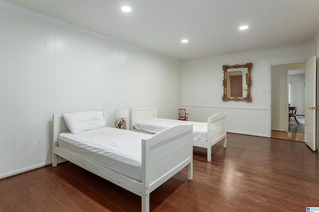 bedroom featuring dark hardwood / wood-style flooring and ornamental molding