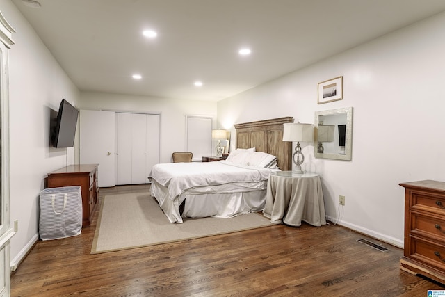 bedroom featuring a closet and dark wood-type flooring