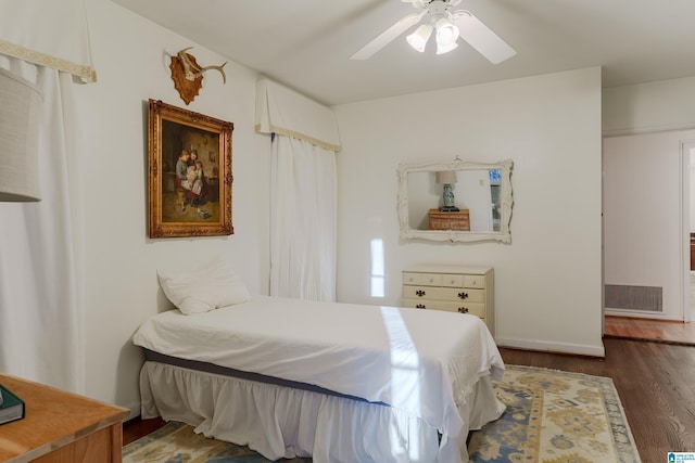 bedroom featuring ceiling fan and dark wood-type flooring