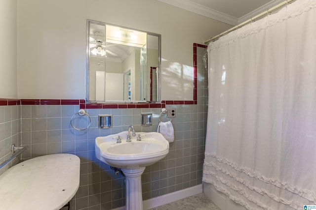 bathroom featuring ceiling fan, curtained shower, ornamental molding, and tile walls