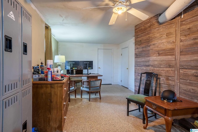 office featuring wooden walls and ceiling fan