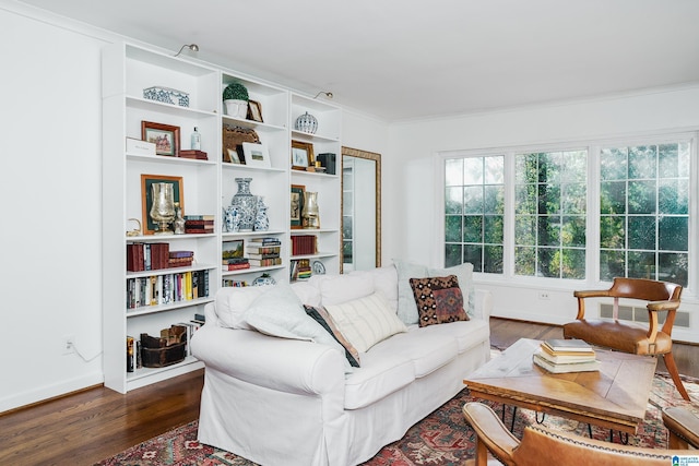 living room featuring dark hardwood / wood-style flooring and crown molding