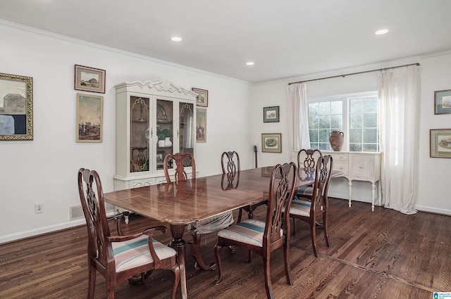 dining space featuring ornamental molding and dark wood-type flooring